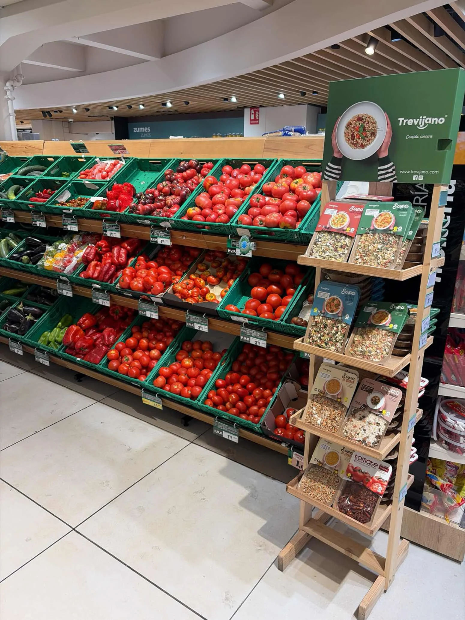 Cherry tomato punnets on a fresh produce shelf